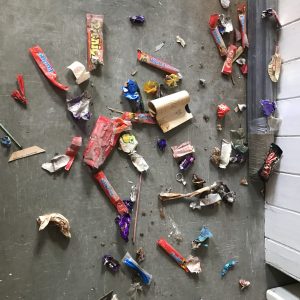 Old sweet papers behind the stairs